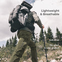 backpacker wearing green hiking pants with a few pockets visible while hiking up mountainside