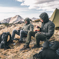 2 backpackers sitting at high elevation camp while wearing puffy down jackets