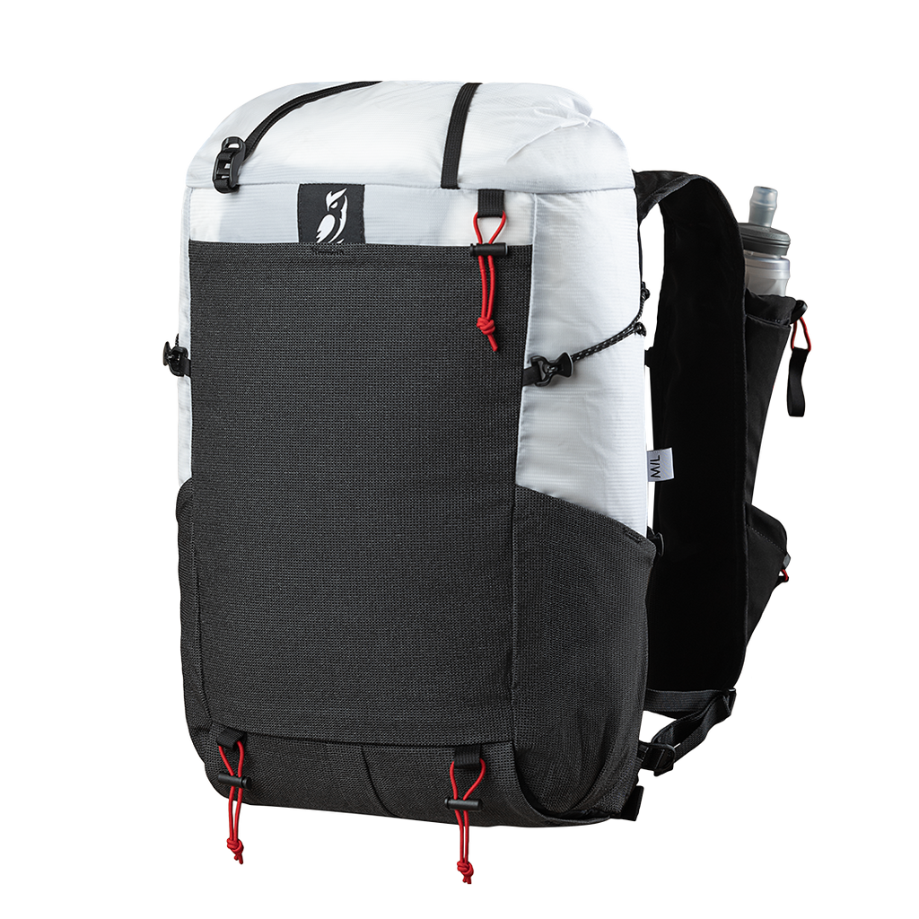 Front side view of the Outdoor Vitals Skyline 30 Fastpack highlighting the expandable front stretch-mesh pocket, side mesh pocket, top roll-closure straps, and running vest harness equipped with a water flask pocket.